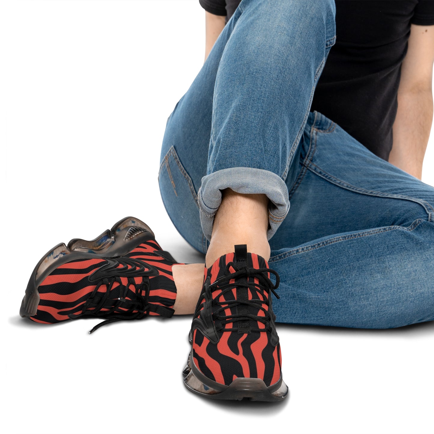 Red and black zebra mesh sneakers worn with jeans, black laces and low profile sole