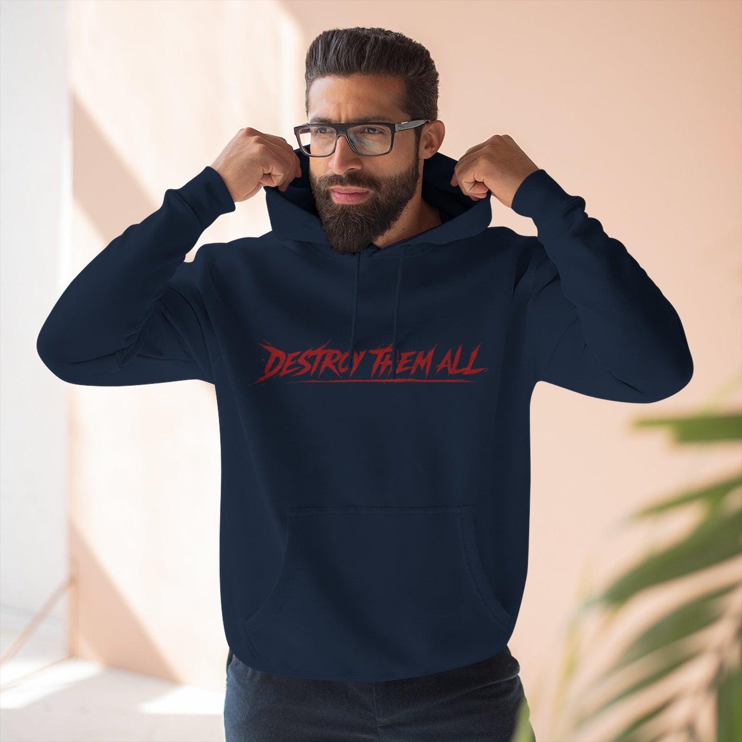 Navy unisex pullover hoodie worn by model, red chest graphic and hood