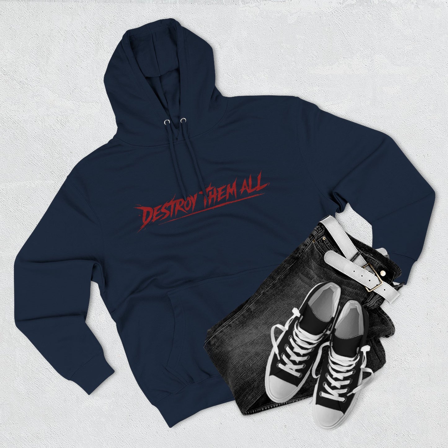 Navy unisex hoodie with red logo, front hood and kangaroo pocket, flat lay with shoes