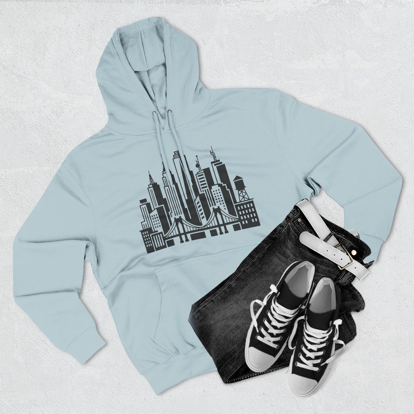 Light blue unisex pullover hoodie with city skyline and bridge graphic on chest