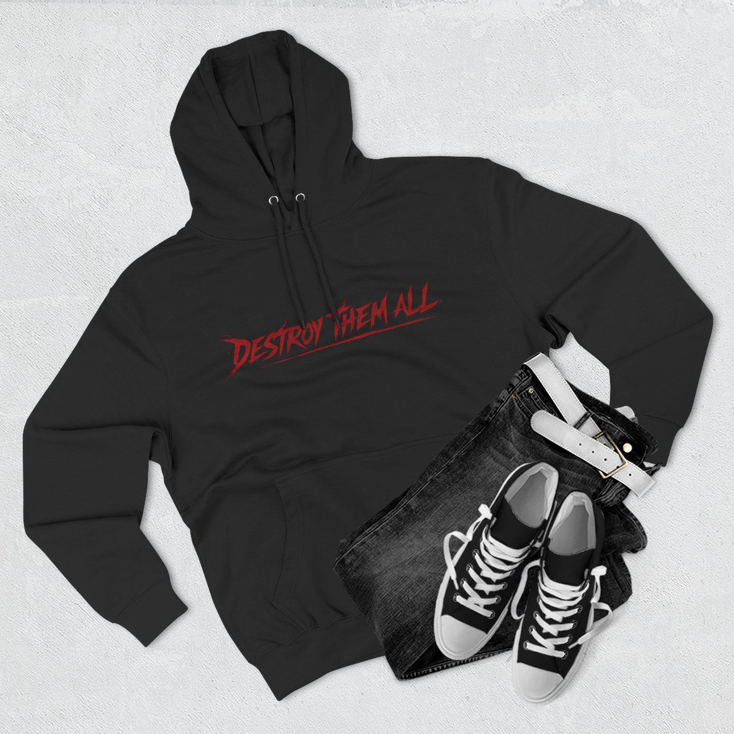 Black unisex hoodie with red logo, front hood and kangaroo pocket, flat lay with shoes