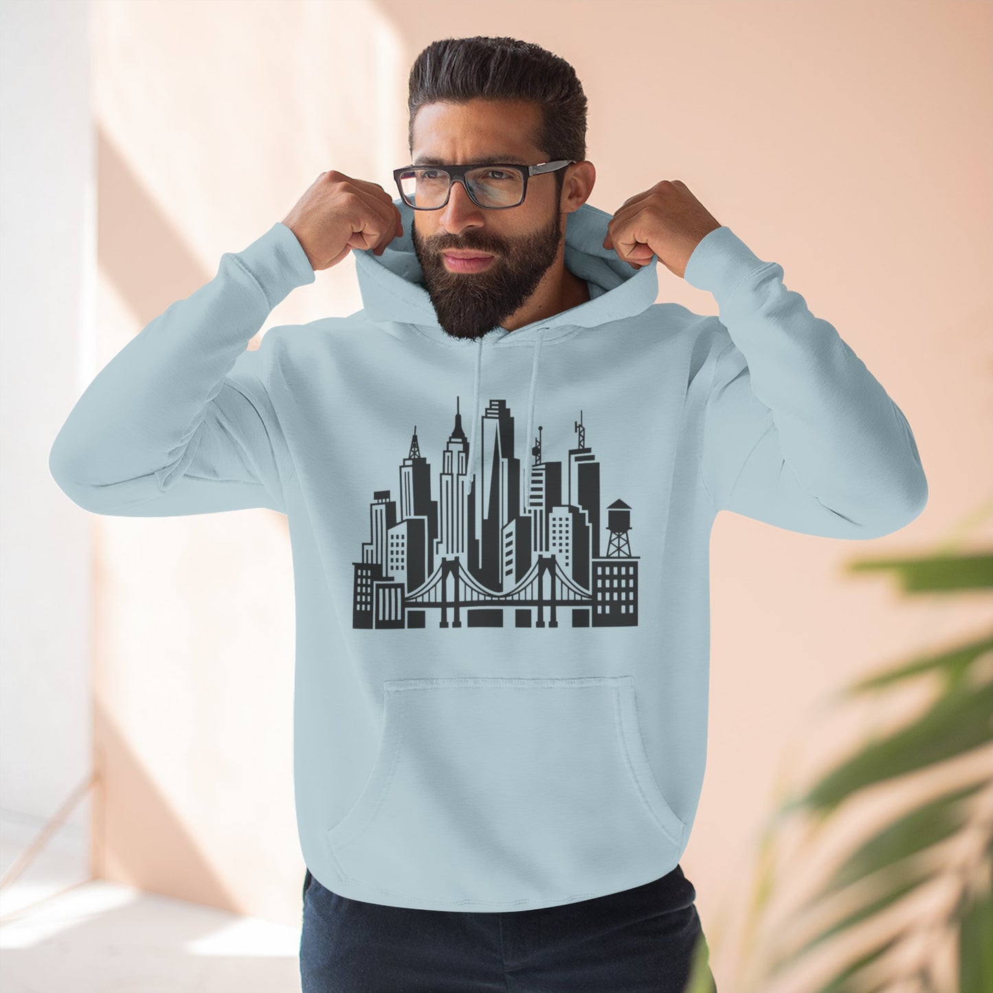 Light blue unisex pullover hoodie with hood and front city skyline and bridge graphic