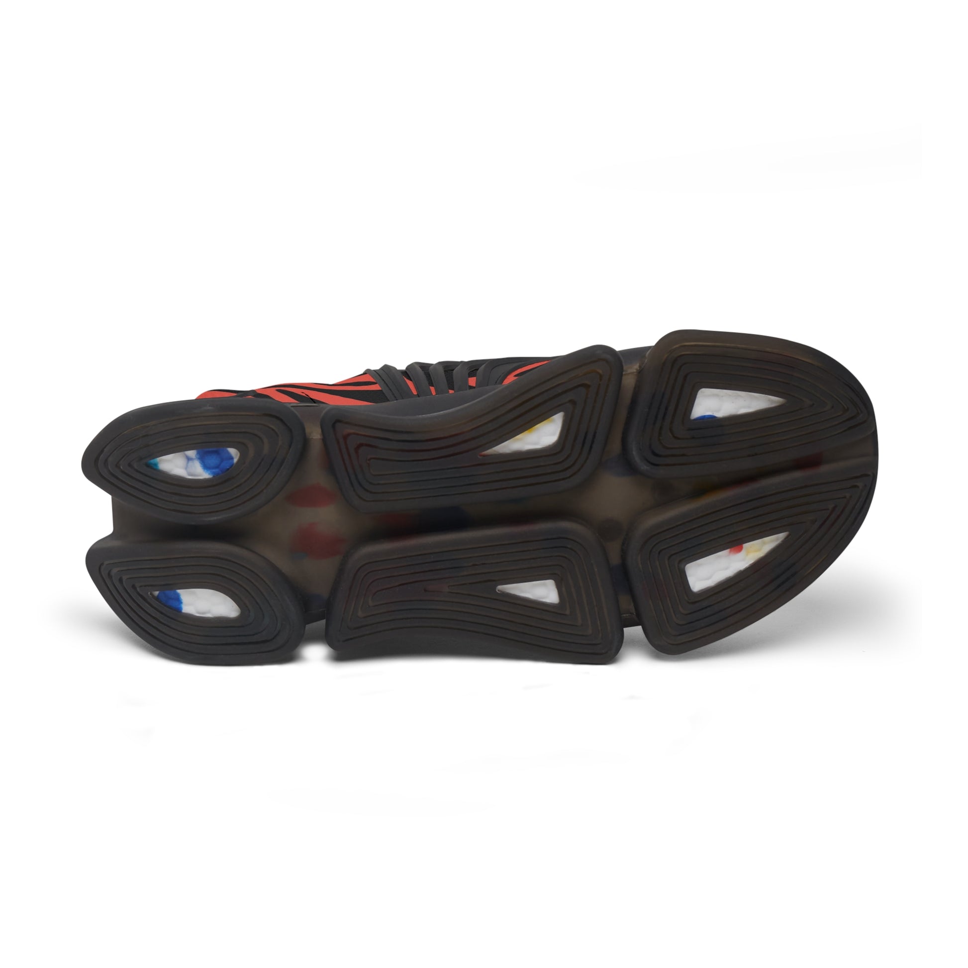 Outsole view of red-and-black zebra mesh sneakers with deep tread and blue accents
