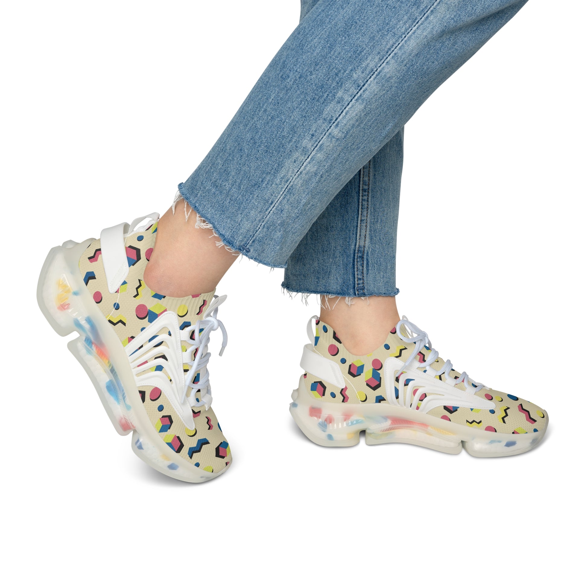 Geometric mesh sneakers with white laces and multicolor print, worn with blue jeans