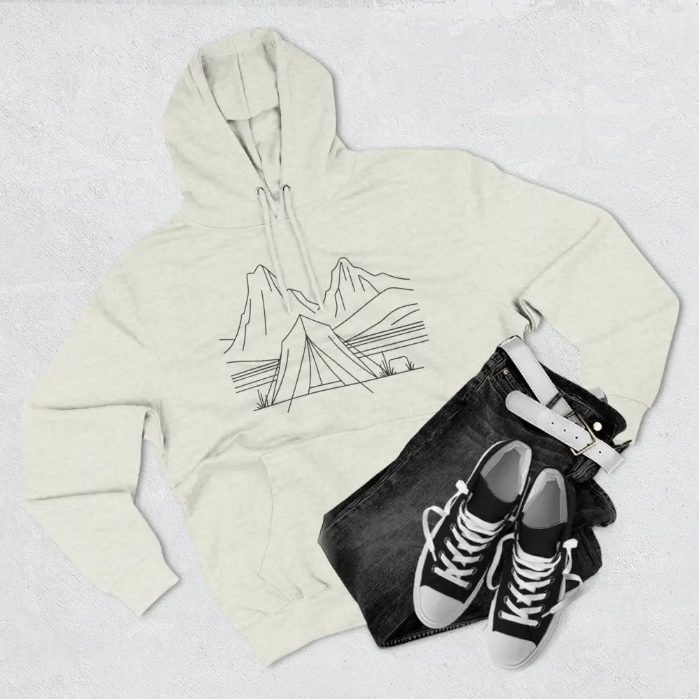 Cream-colored unisex hoodie with minimalist mountain and tent graphic, luxurious fleece, spacious kangaroo pocket