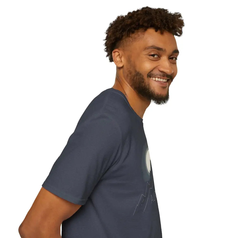 Bearded man with curly hair wearing Aurora Mountain Adventure Tee with ribbed knit collar
