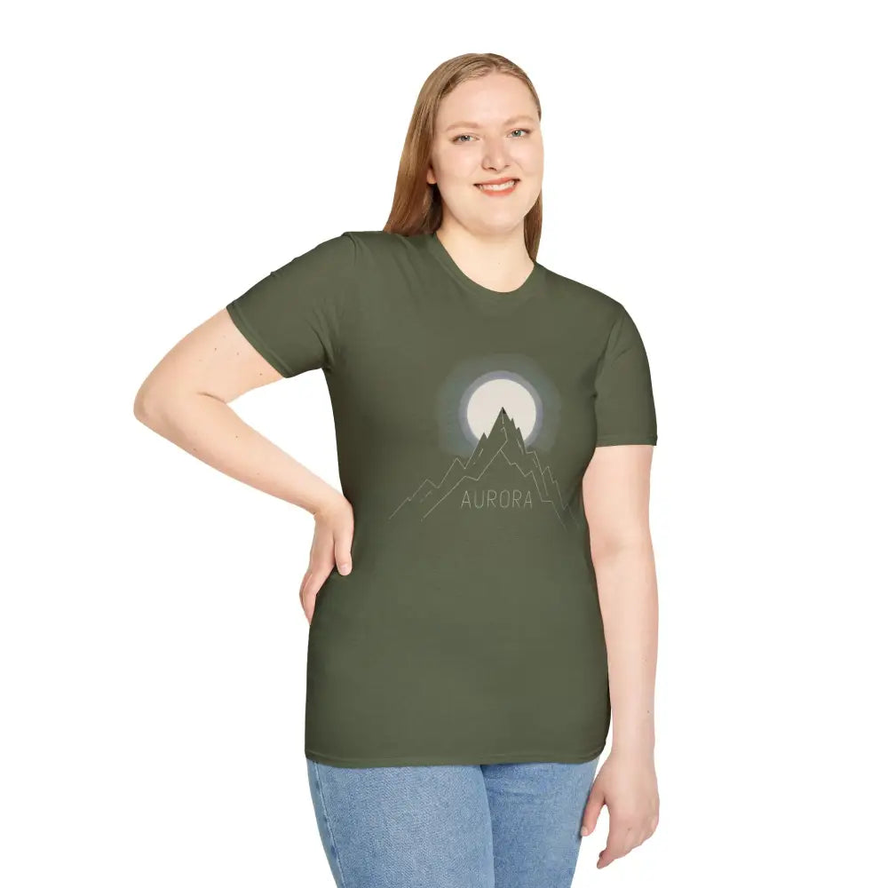 Woman wearing olive green Aurora Mountain unisex T-shirt with mountain and moon graphic, softstyle design