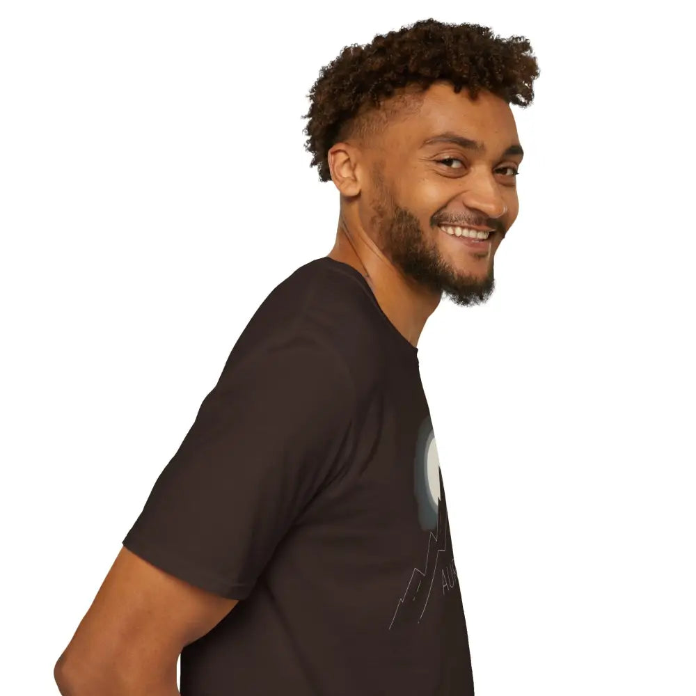 Man with curly hair and beard wearing Aurora Mountain Adventure Tee with ribbed knit collar