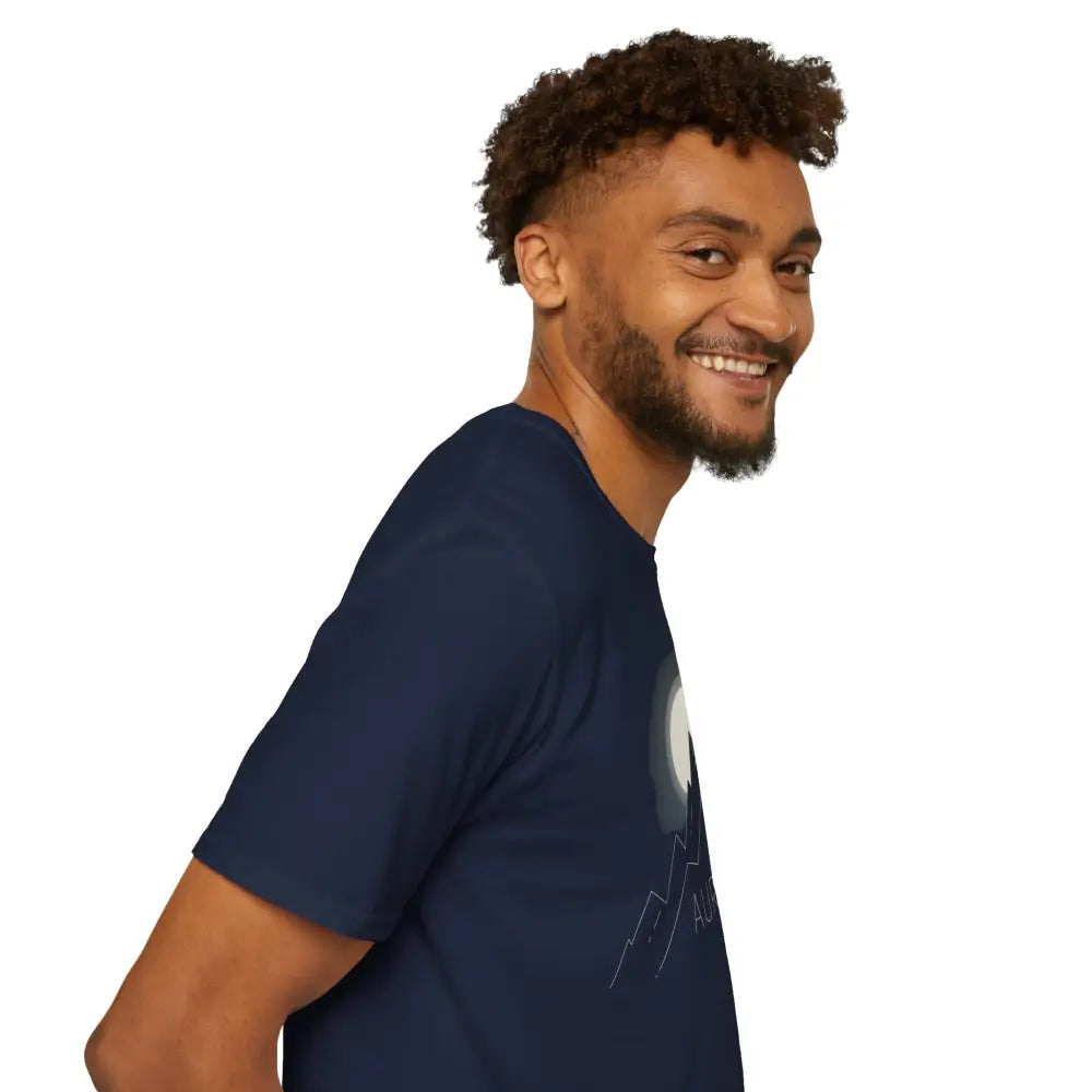 Smiling man in navy Aurora Mountain T-Shirt with moon and mountain graphic, ribbed collar