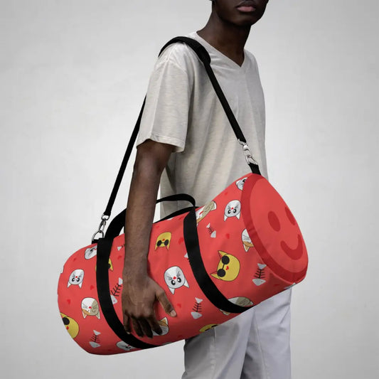 Red duffel bag with cartoon cat faces and smiling emoji, perfect favorite travel companion