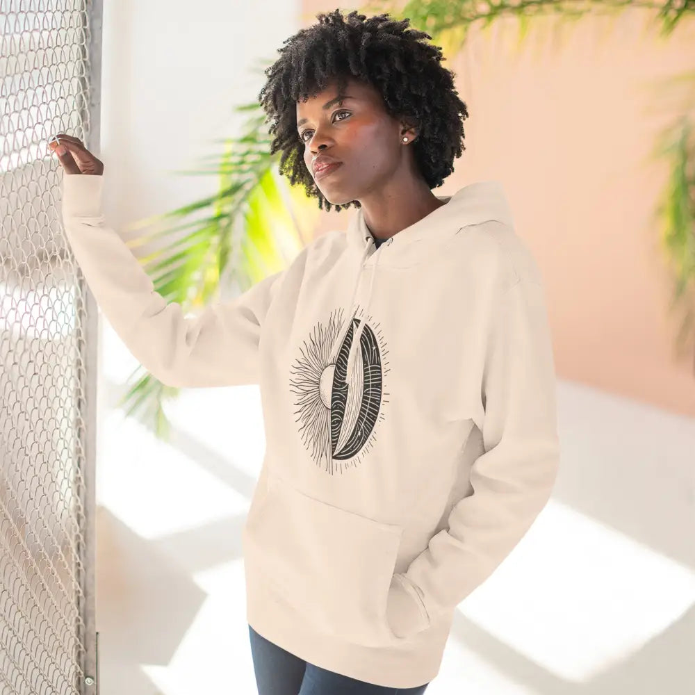 Woman wearing a celestial-themed cozy fleece hoodie with moon and sun graphic and spacious kangaroo pocket