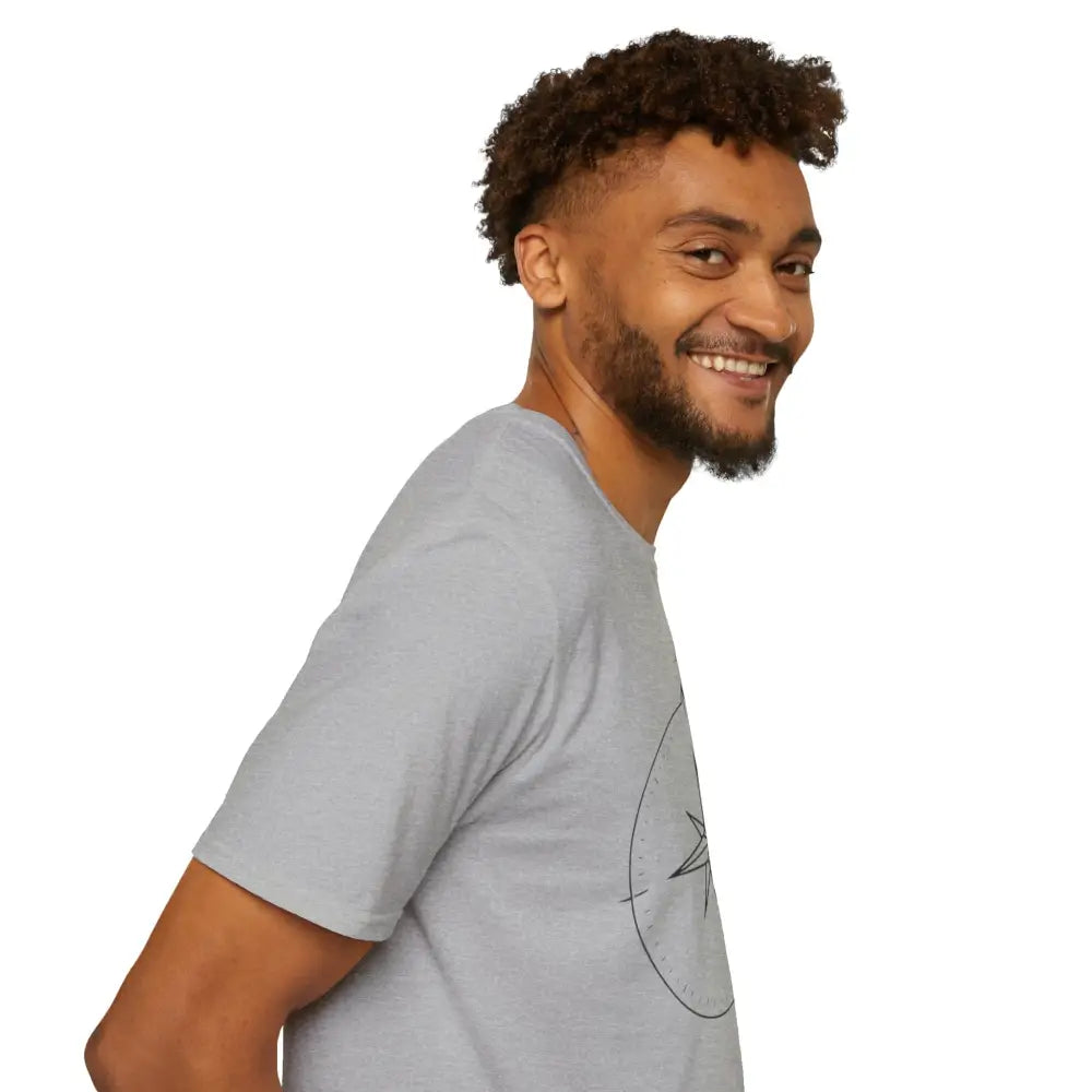 Smiling man with beard and curly hair wearing a light gray compass graphic T-shirt made of ring-spun cotton for outdoor activities