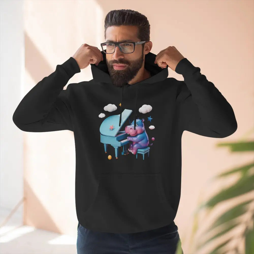 Black fleece hoodie with cartoon hippopotamus playing a light blue piano, cozy and delightful fleece hoodie for music lovers