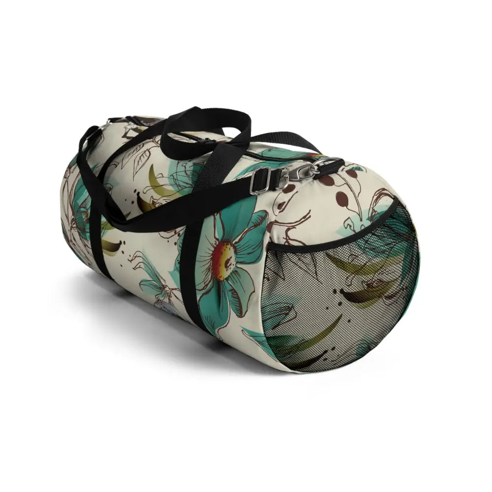 Floral print duffel bag with black straps and mesh side pocket, perfect travel companion