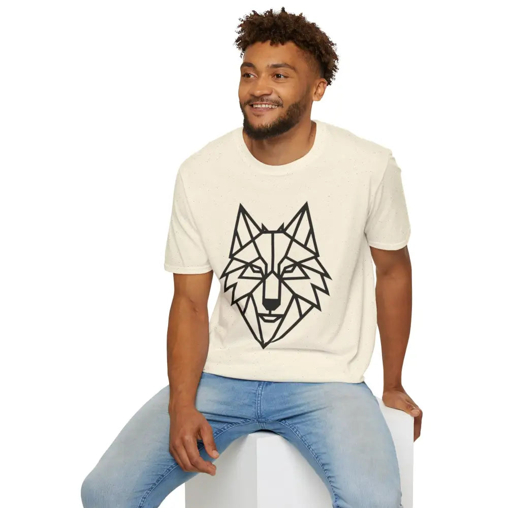 Man wearing a light-colored geometric wolf softstyle tee with light blue jeans