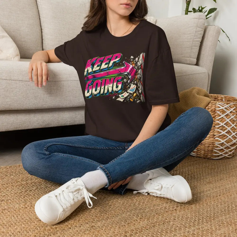 Black short-sleeved keep going unisex t-shirt with neon pink green blue graphic and care instructions for low heat tumble dry