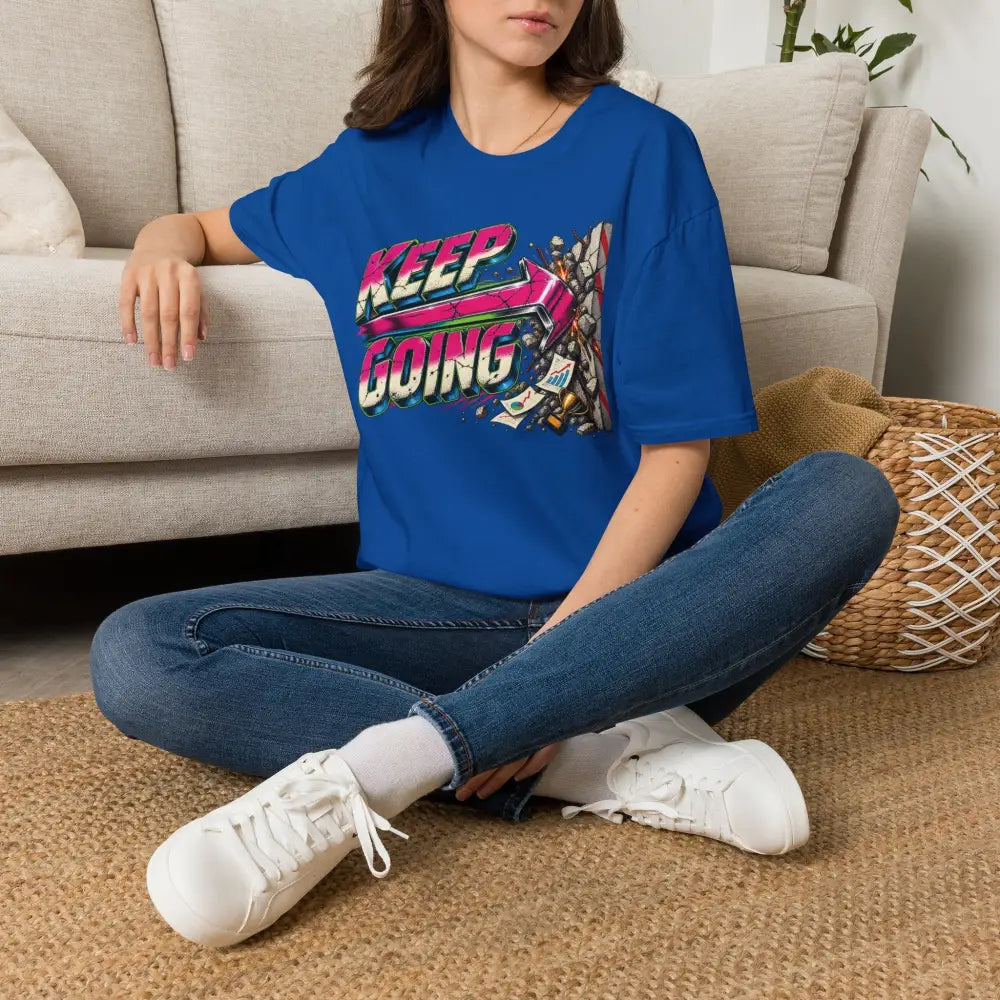 Blue cotton keep going unisex t-shirt with neon pink purple green graphic and care instructions for low heat tumble dry