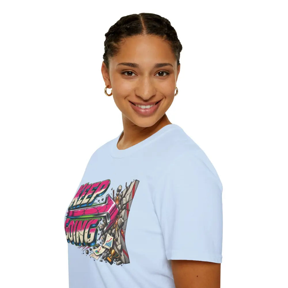 Light blue cotton keep going unisex t-shirt with vibrant graffiti graphic and care instructions to tumble dry low heat