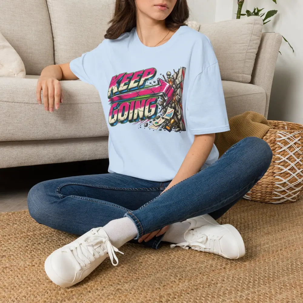 Light blue cotton keep going unisex t-shirt with vibrant pink yellow and black graphic, low heat tumble dry care instructions