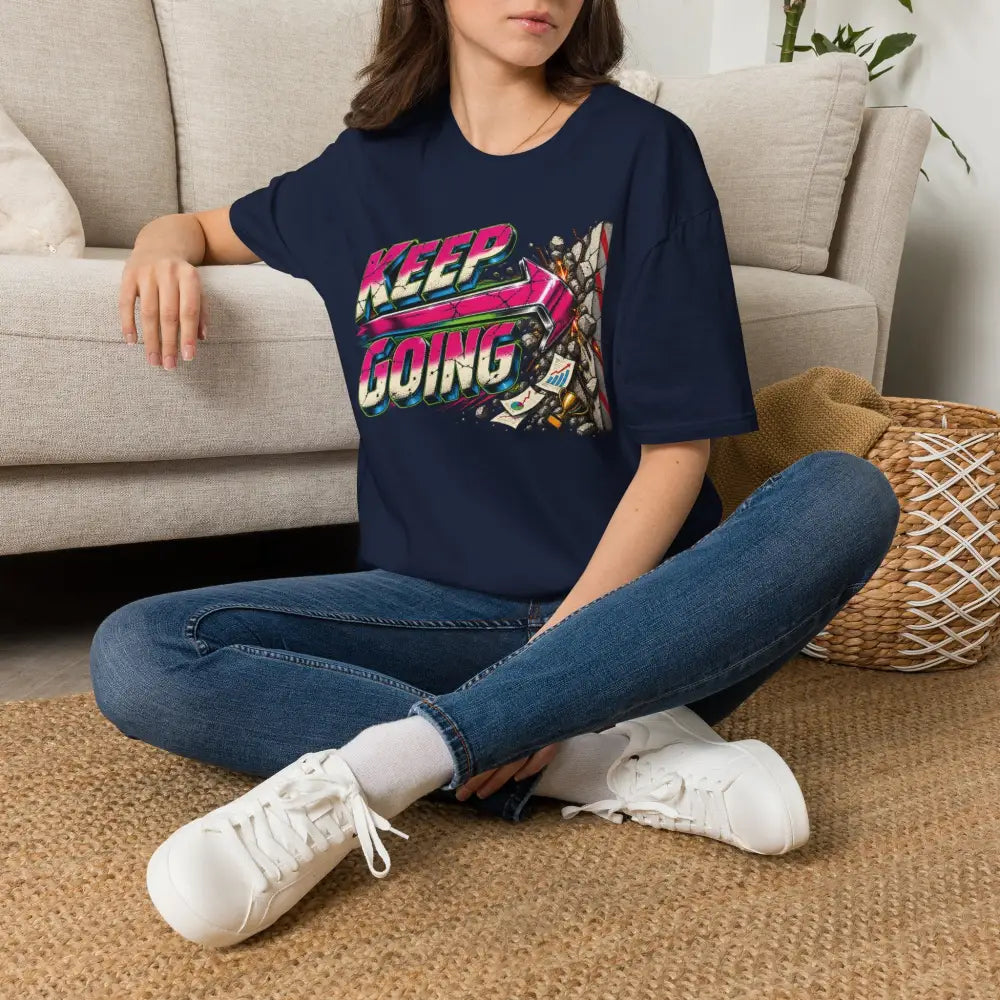 Navy blue oversized unisex t-shirt with vibrant keep going neon graphic and low heat care instructions for tumble dry
