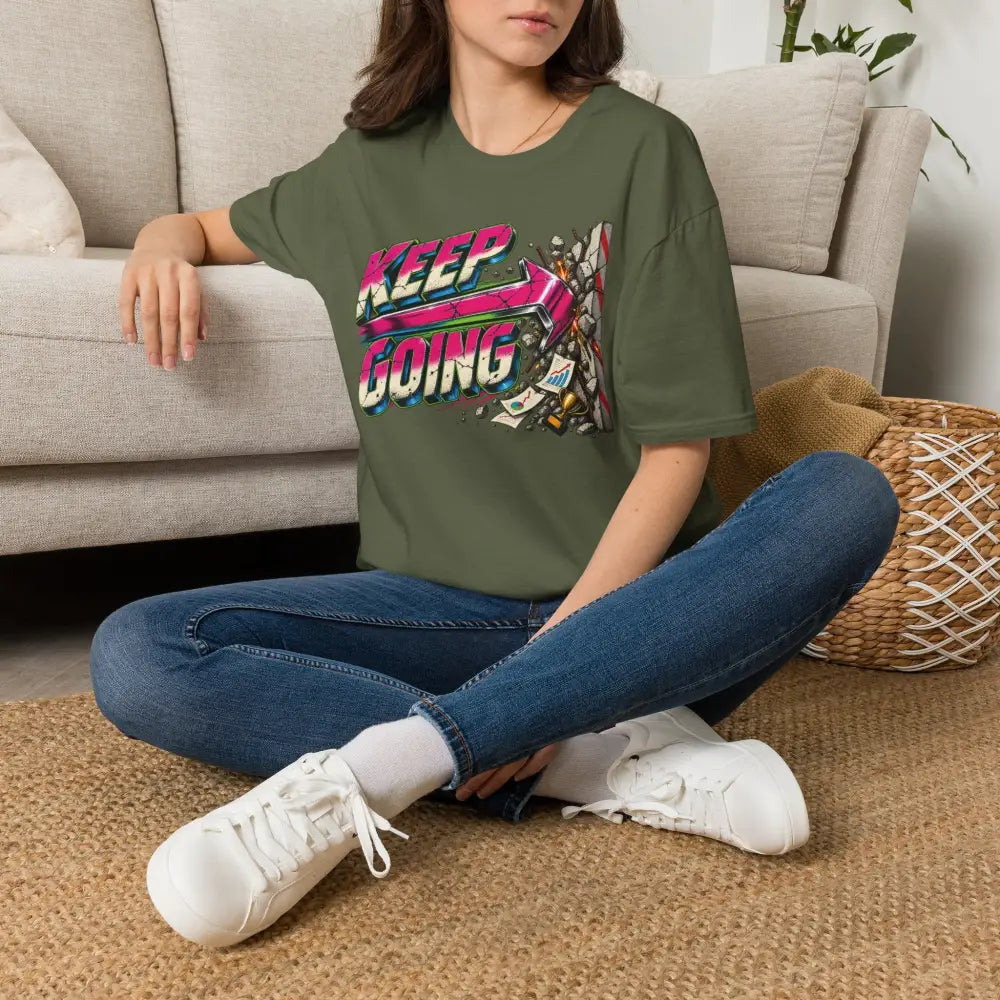 Olive green short-sleeved keep going unisex t-shirt with neon graphic design, low heat tumble dry care instructions