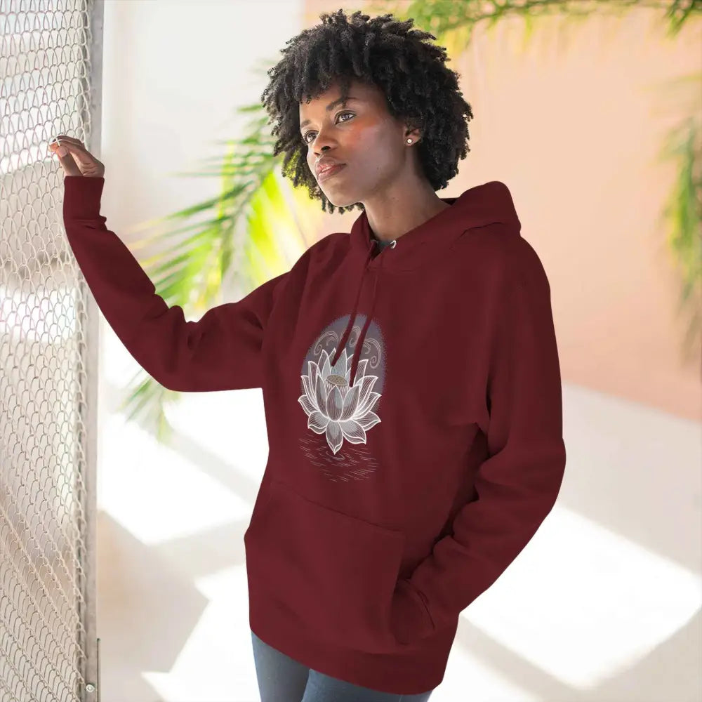 Woman wearing maroon Lotus Blossom Fleece Unisex Hoodie with three-panel fleece and spacious kangaroo pocket