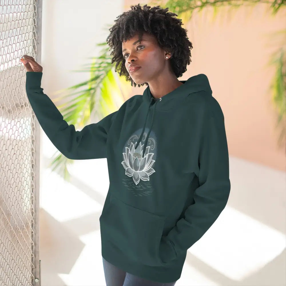 Woman wearing dark green Lotus Blossom Fleece Unisex Hoodie with white lotus design and spacious kangaroo pocket