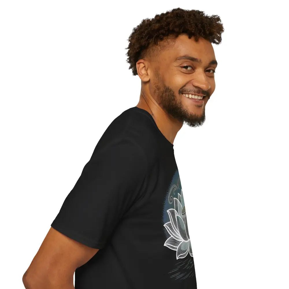 Man wearing a black Lotus Blossom Unisex Softstyle T-Shirt with a white lotus design for yoga and mindfulness