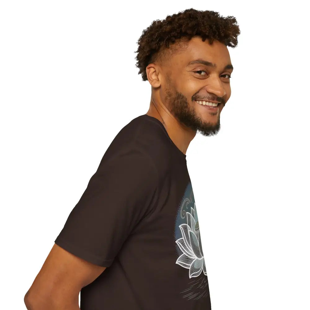 Smiling man with dark curly hair wearing a Lotus Blossom Unisex Softstyle T-Shirt with lotus design