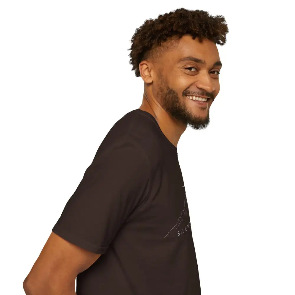 Man with beard and curly hair wearing a softstyle mountain-themed T-shirt with ribbed knit collar