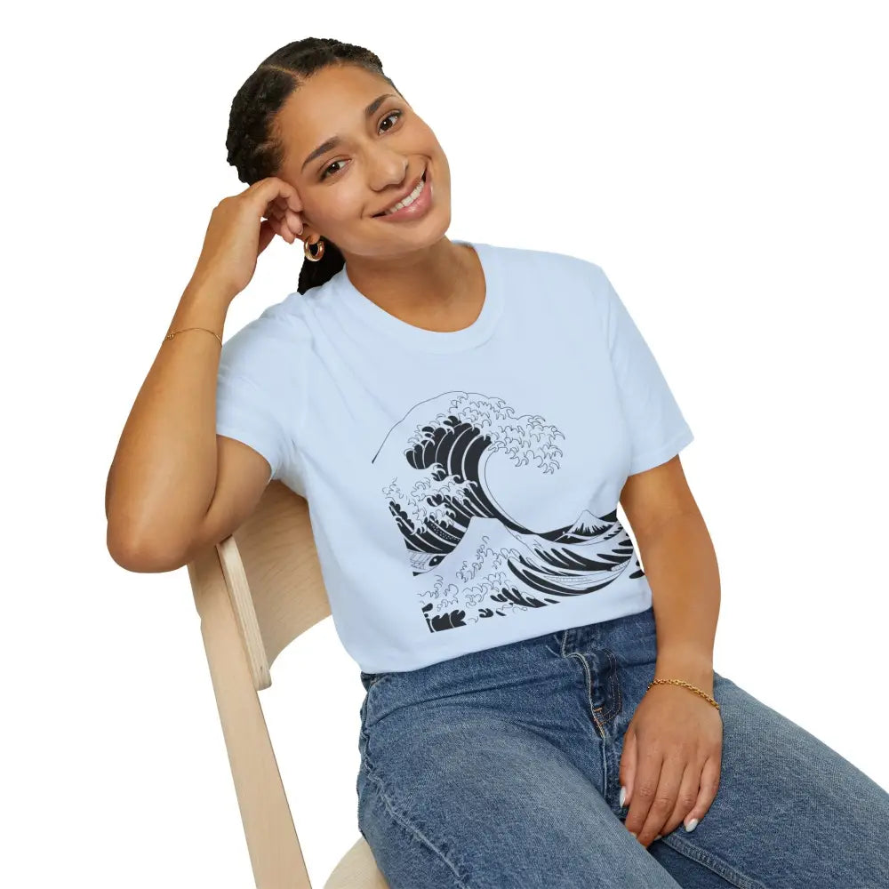 Woman in ocean wave unisex t-shirt with black graphic and blue jeans, casual summer style