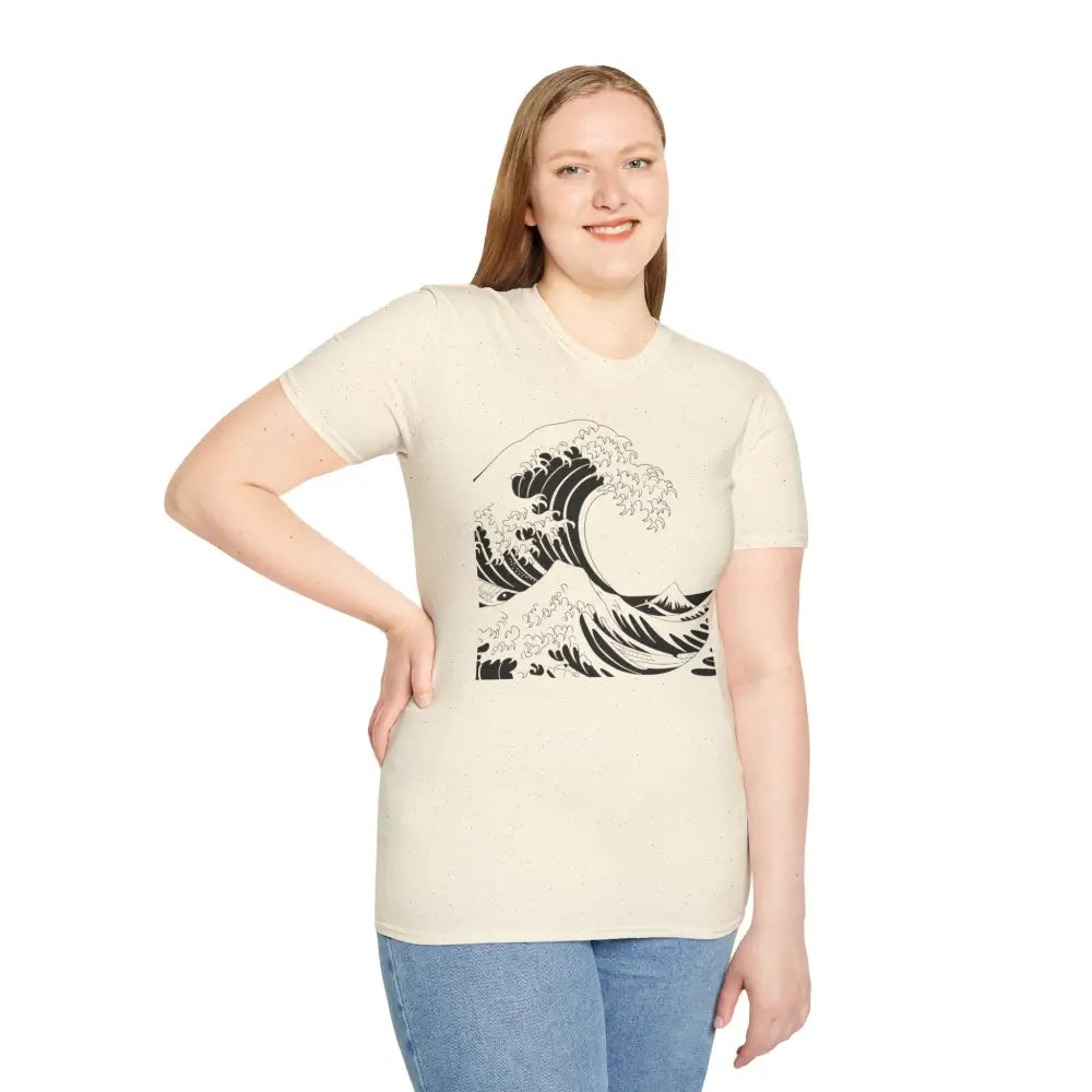 Woman modeling cream-colored unisex t-shirt with black wave graphic, soft and highly elastic ribbed fabric