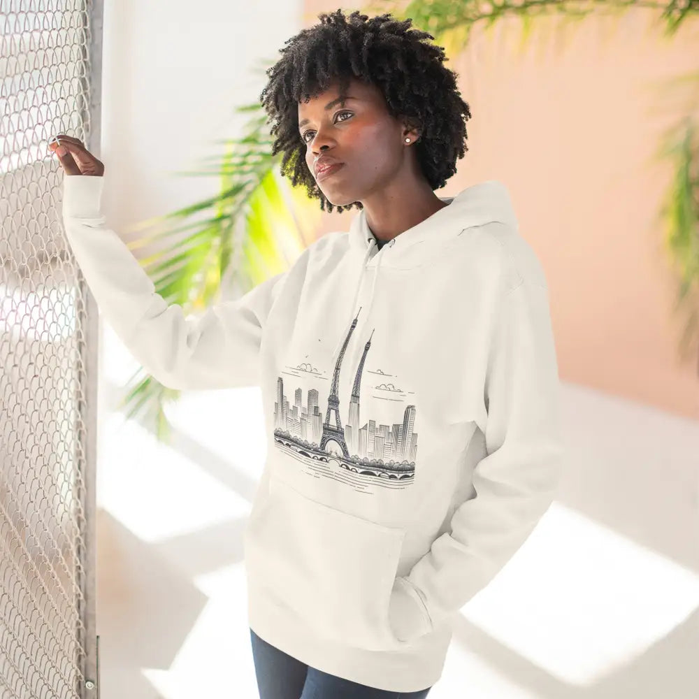 Woman wearing Paris Skyline fleece hoodie with graphic, cozy streetwear, and kangaroo pouch