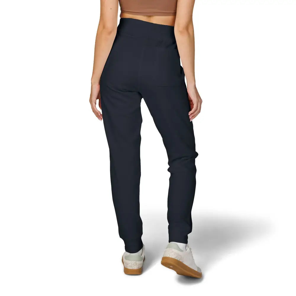 High-waisted dark blue unisex fleece sweatpants with white sneakers, cozy low-heat loungewear