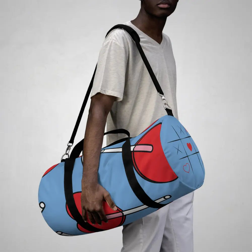 Stylish duffel bag in blue and red with black straps, ideal for gym and travel