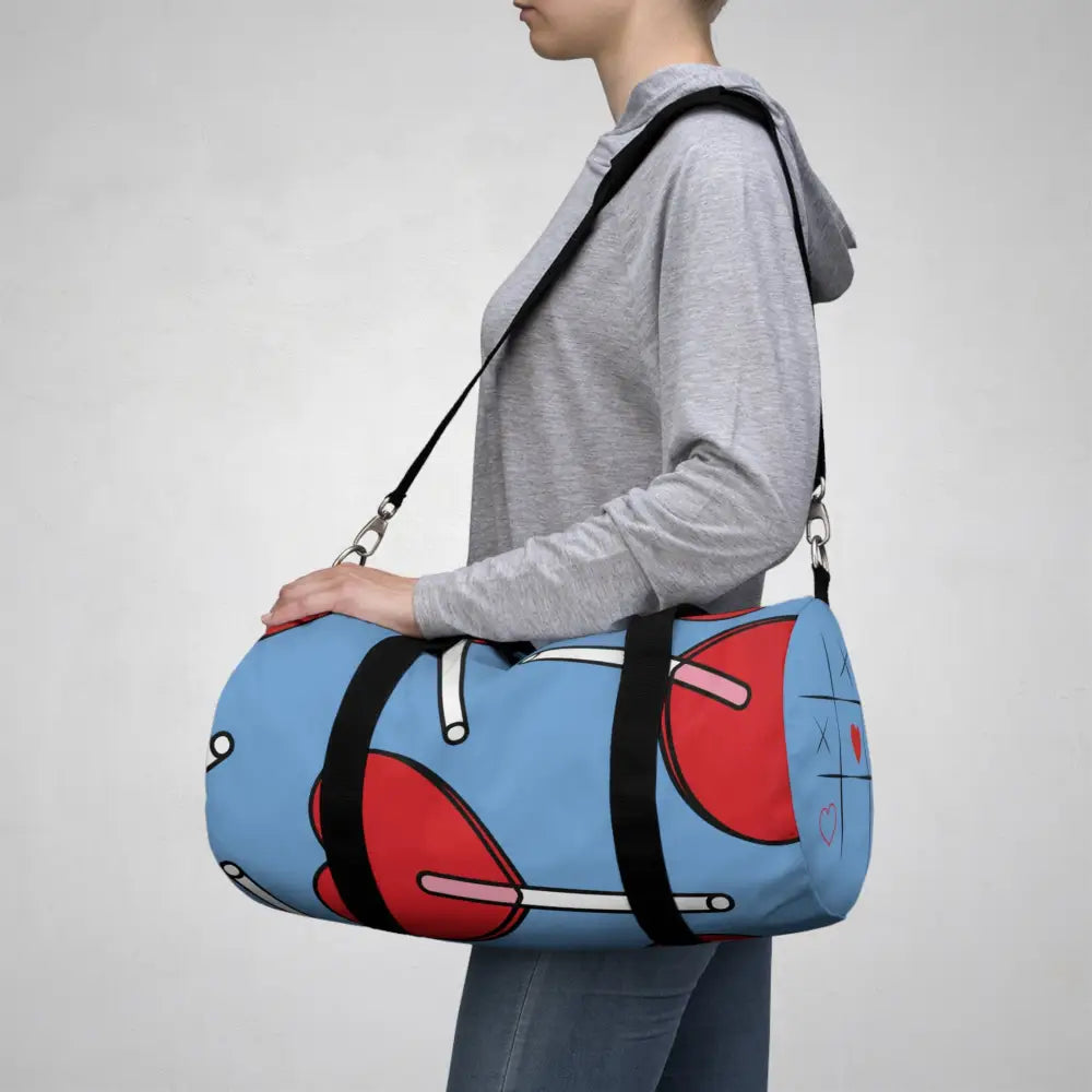 Light blue duffel bag with red heart designs and black straps, stylish duffel bag for kids