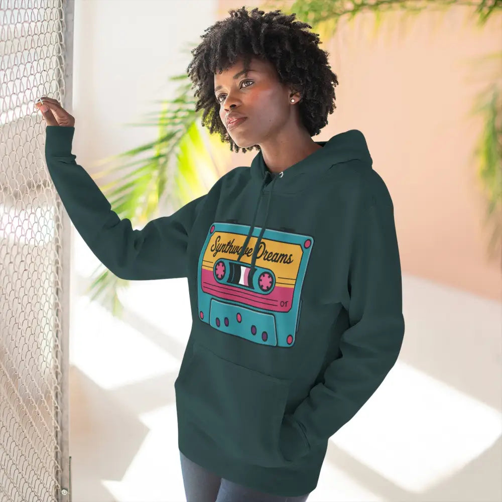 Woman in dark teal hoodie with colorful cassette tape graphic, vintage music streetwear