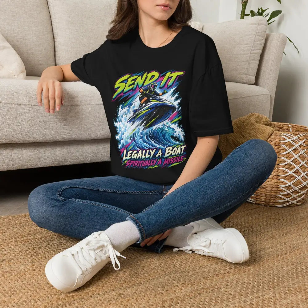 Black oversized unisex t-shirt with neon jet ski rider graphic and send it legally a boat spiritually a missile text with low heat care instructions for tumble dry