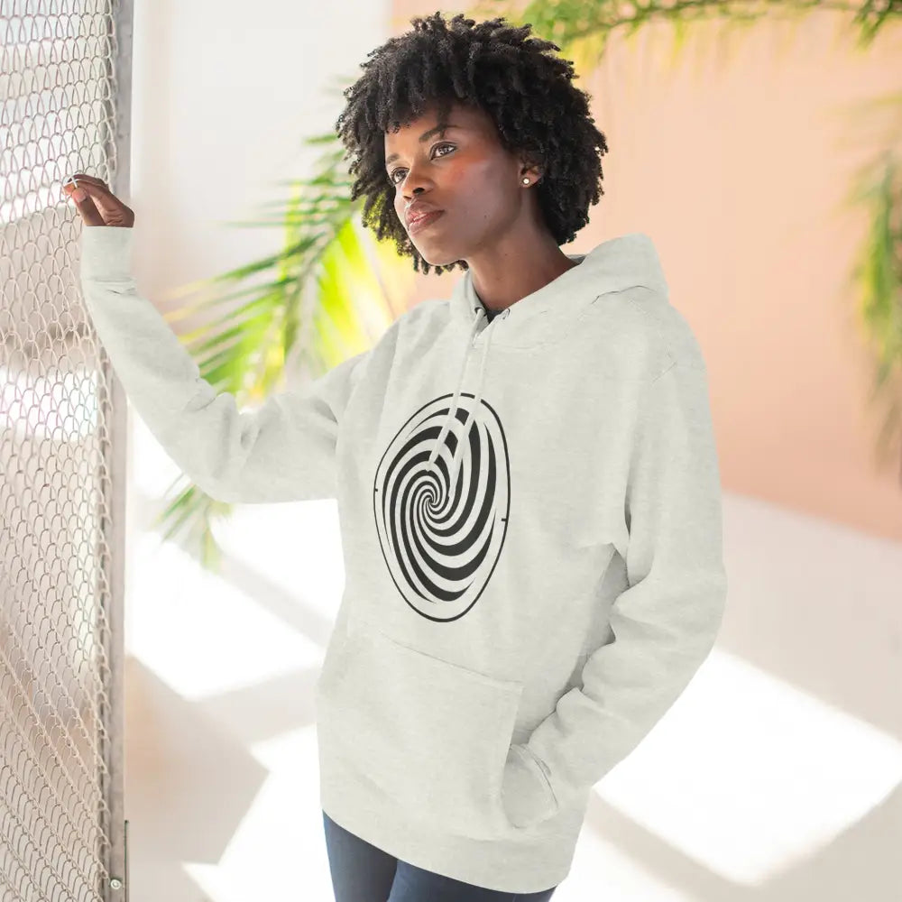 Person wearing a white fleece hoodie with black spiral design and spacious kangaroo pocket