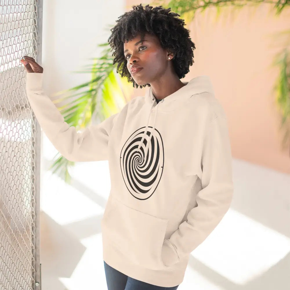 Woman modeling cream-colored fleece hoodie with black spiral design and spacious kangaroo pocket