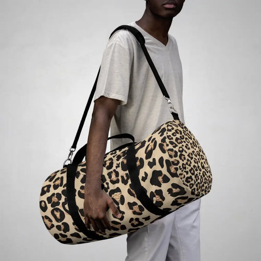 Chic leopard print duffel bag with black straps, adjustable shoulder strap, and internal zipper pocket