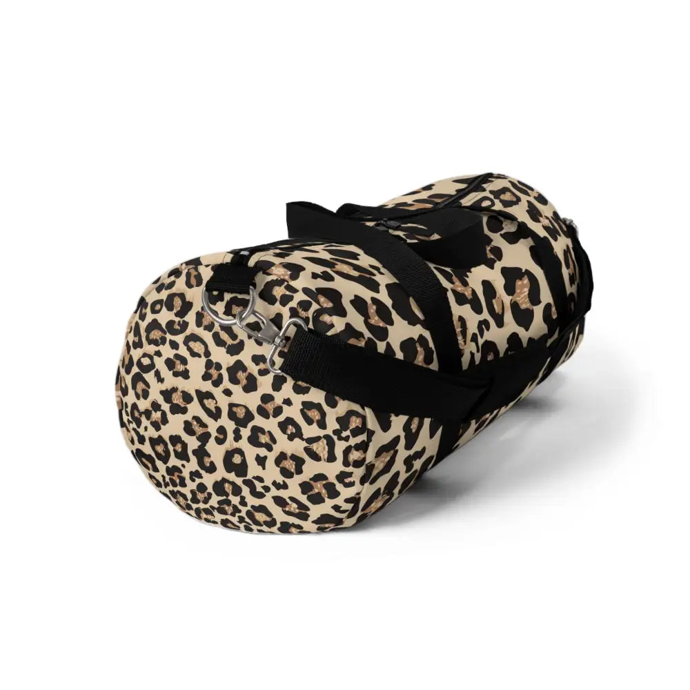 Chic leopard print duffel bag with black straps, adjustable shoulder strap, and internal zipper pocket