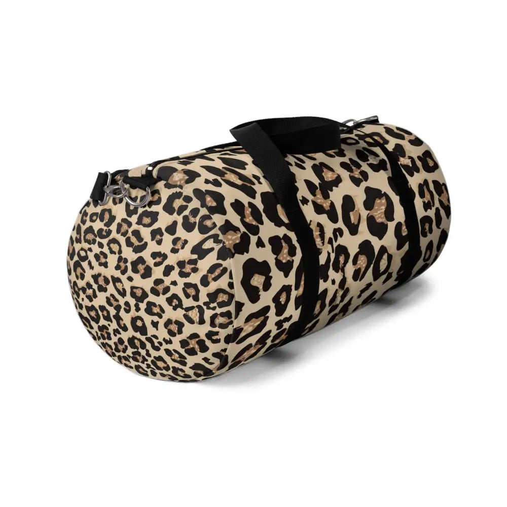 Chic leopard print duffel bag with black straps, zipper closures, and adjustable shoulder strap