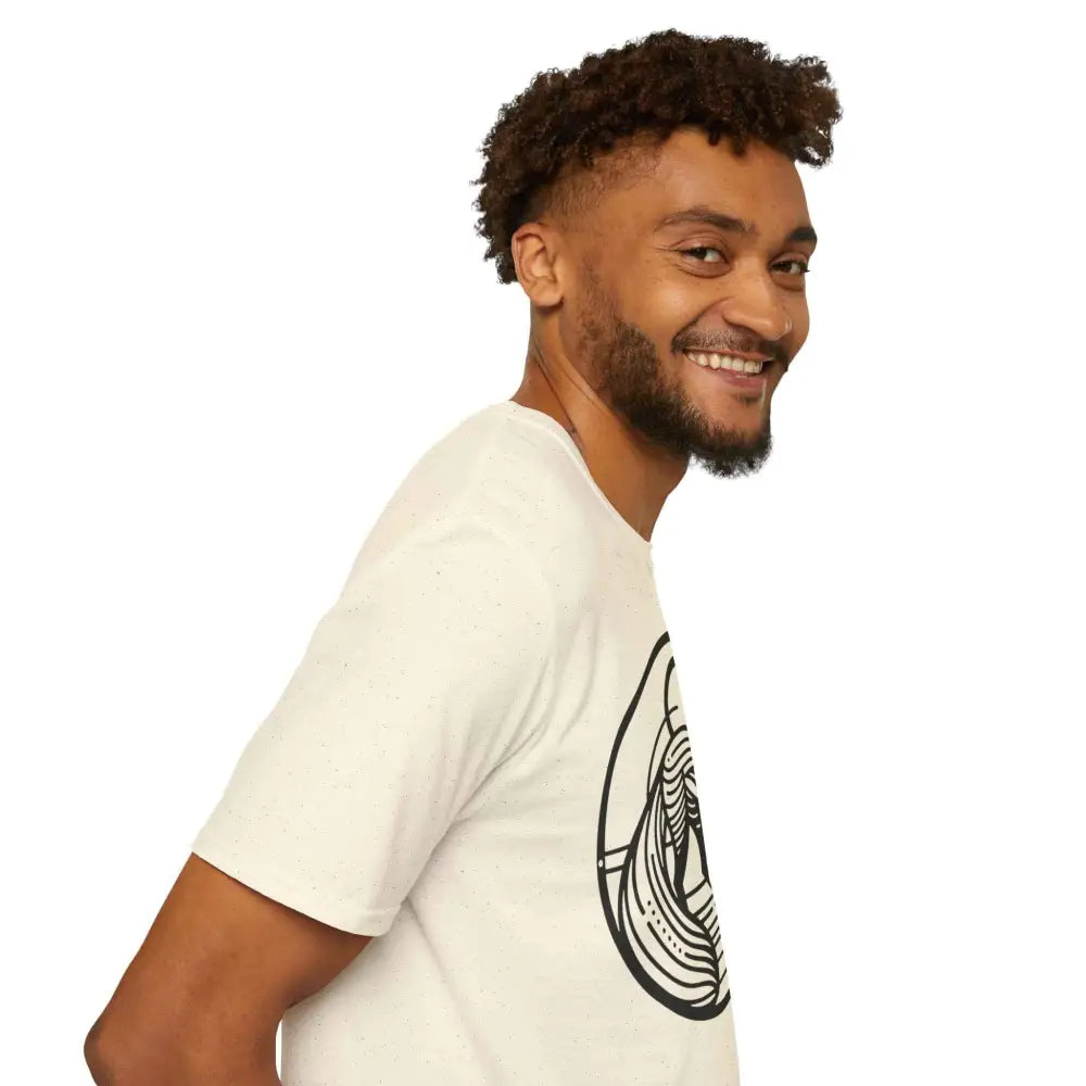 Smiling man with beard and curly hair wearing a light-colored graphic T-shirt, perfect for summer fashion