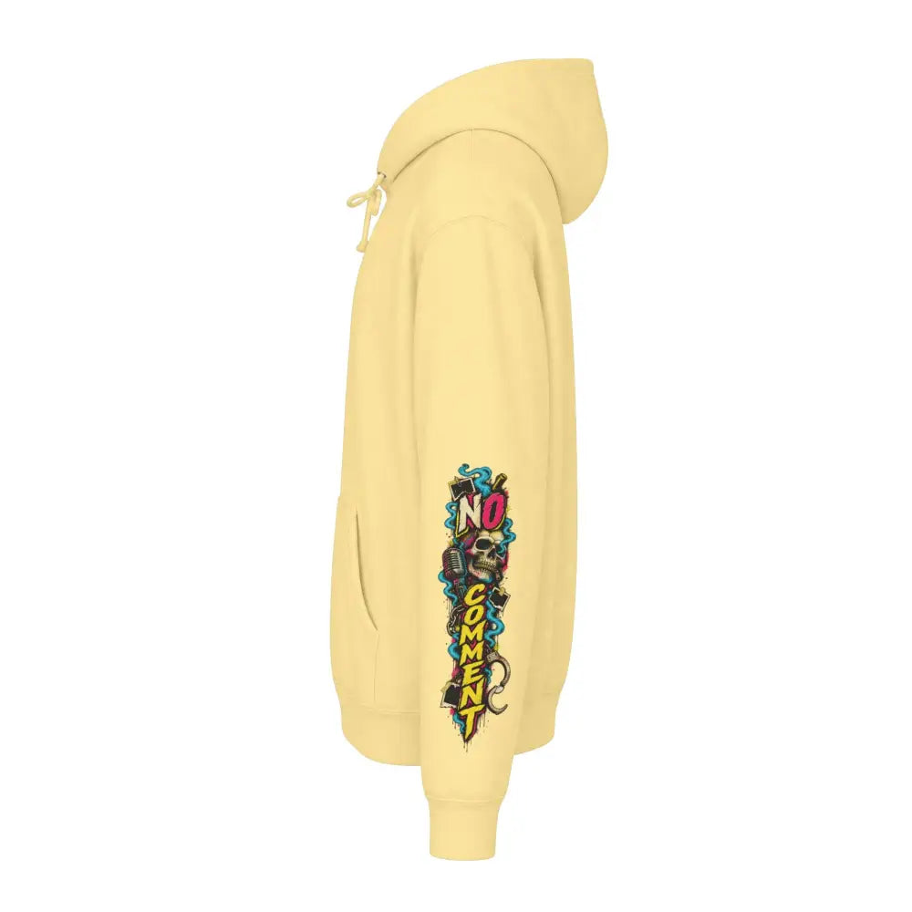 Unisex pale yellow heavyweight hooded sweatshirt featuring a bold graffiti style no comment graphic with skulls and microphones on sleeve