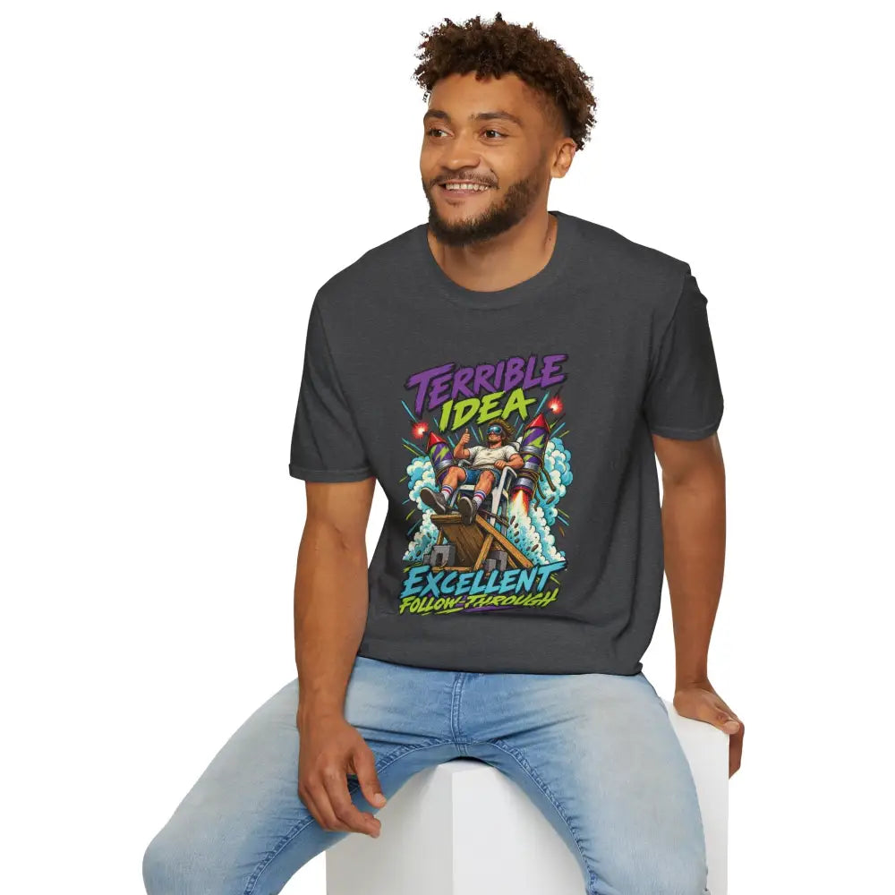 Dark gray cotton unisex t-shirt with vibrant cartoon rocket graphic and terrible idea excellent follow-through text care instructions recommend low heat tumble dry