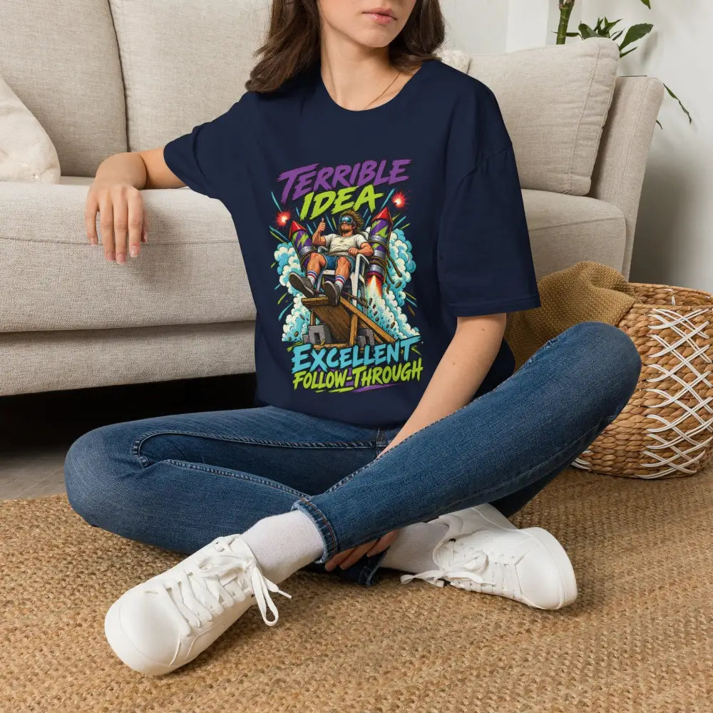 Navy blue oversized unisex t-shirt with retro rocket graphic and text terrible idea excellent follow-through low heat tumble dry care instructions