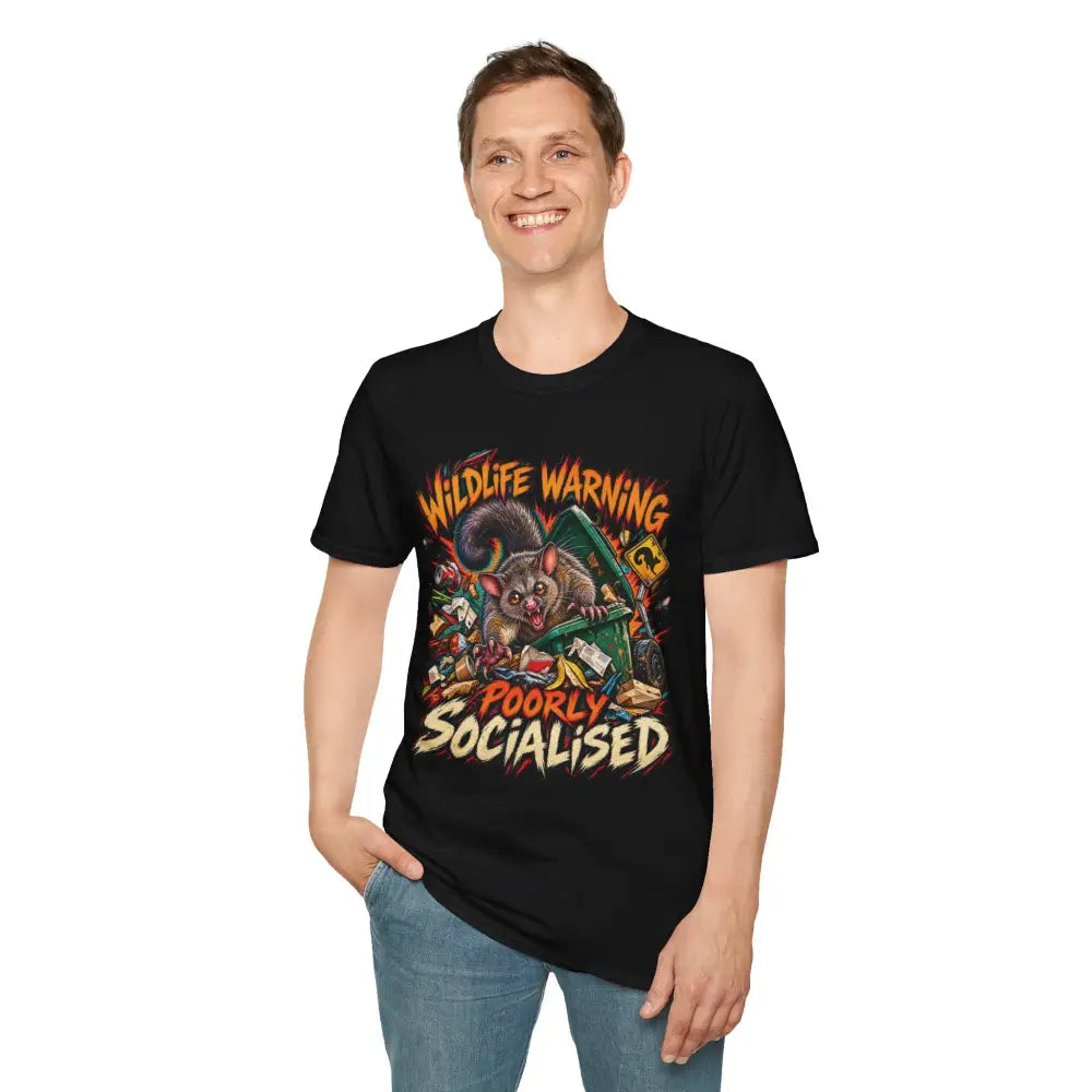 Unisex black ring-spun cotton t-shirt with colorful cartoon possum graphic and wildlife warning text, care instructions low heat