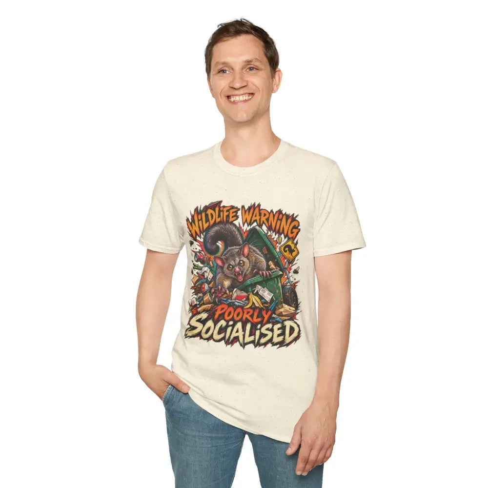 Cream-colored ring-spun cotton unisex t-shirt with vibrant cartoon possum and wildlife warning poorly socialised text, low heat care instructions