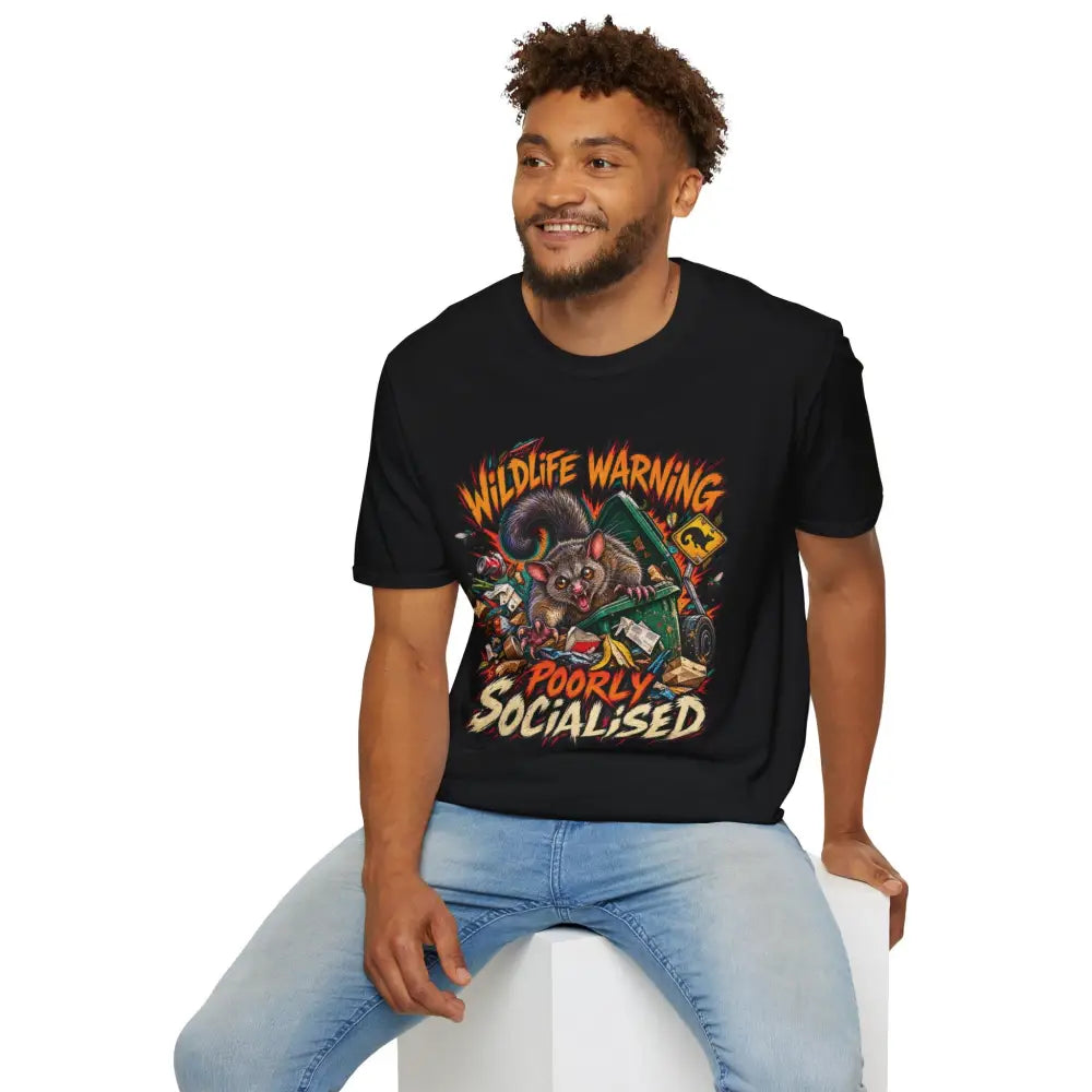 Unisex black ring-spun cotton t-shirt with colorful cartoon possum and wildlife warning text, low heat care instructions